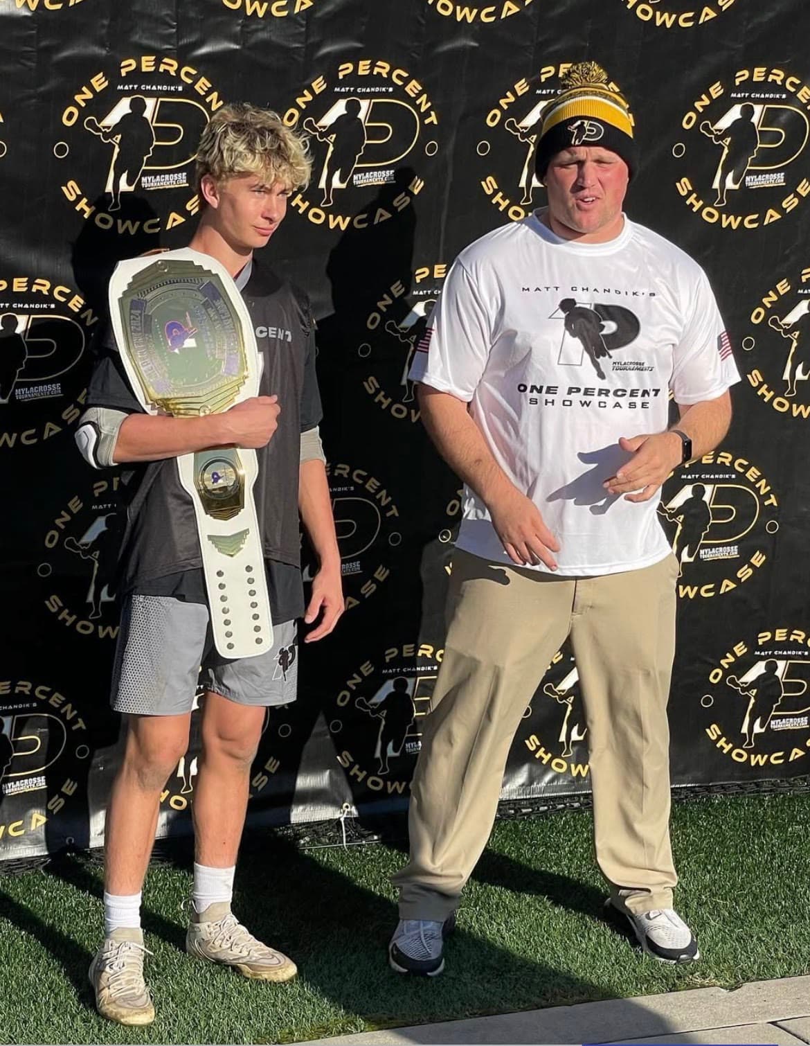 Laird Miller holding an MVP tournament belt from lacrosse