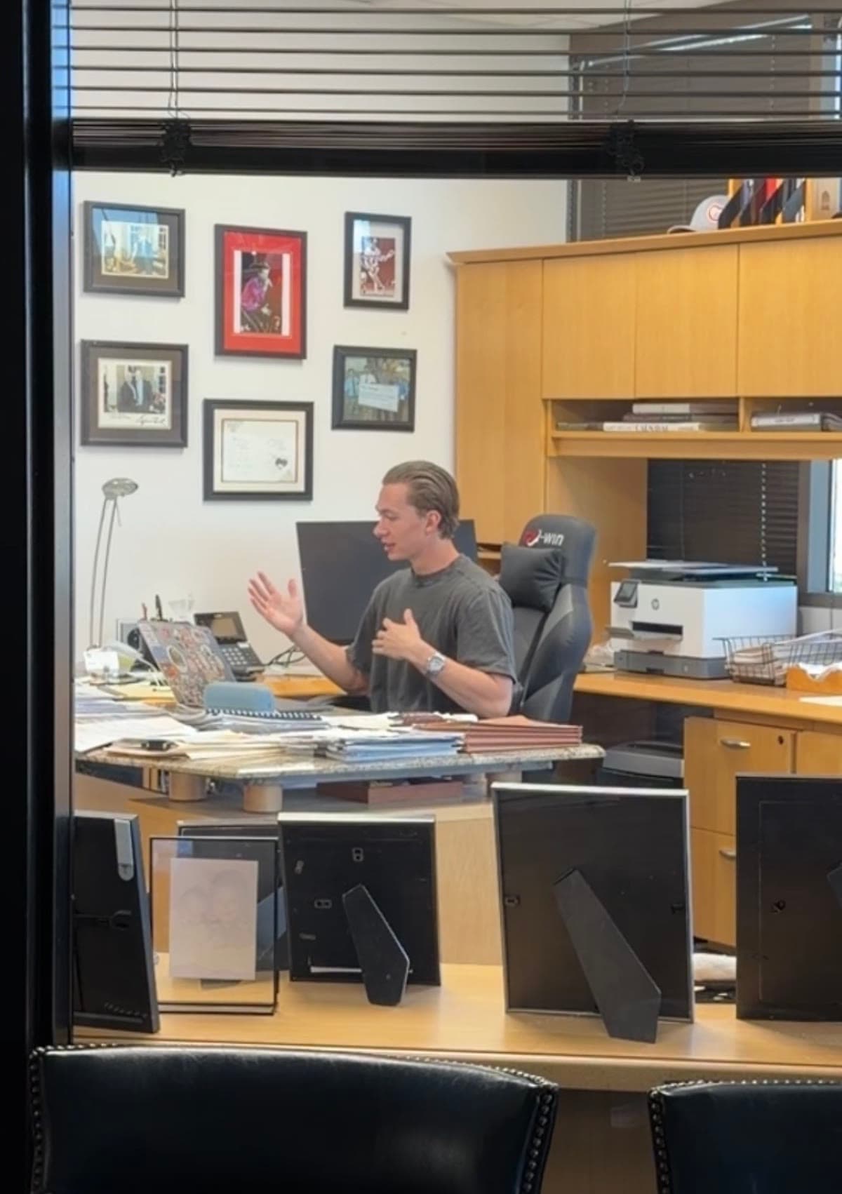 Laird Miller recording content and explaining AI systems in an office