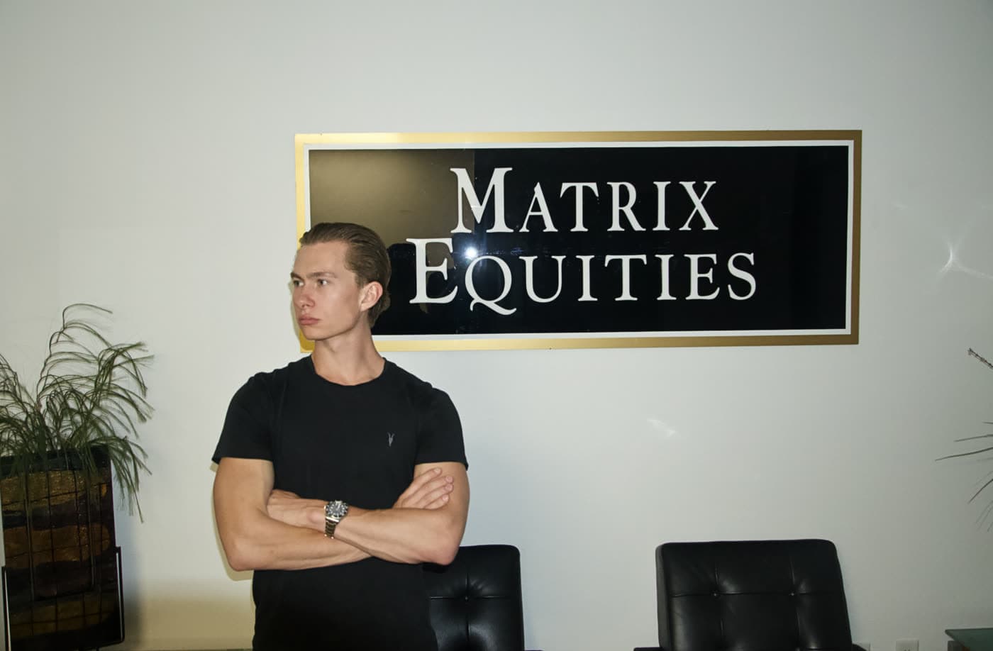 Laird Miller in front of the Matrix Equities sign
