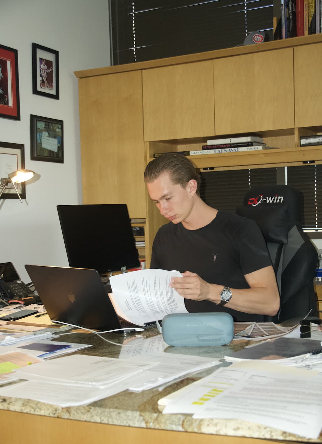 Laird Miller working in an office with real estate files and underwriting materials