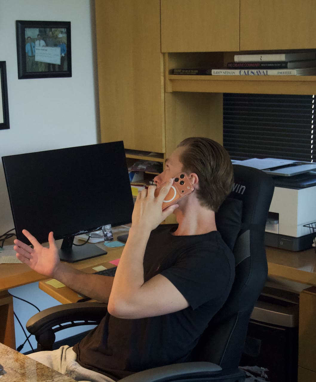 Laird Miller on the phone in an office, representing client communication and AI intake systems